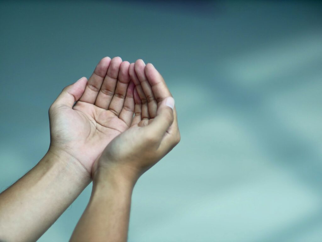 a person holding their hands in the air