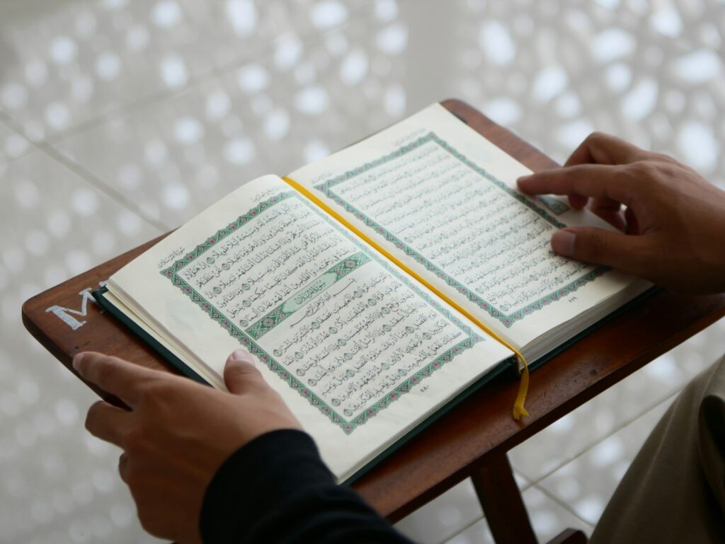 a person sitting at a table with an open book